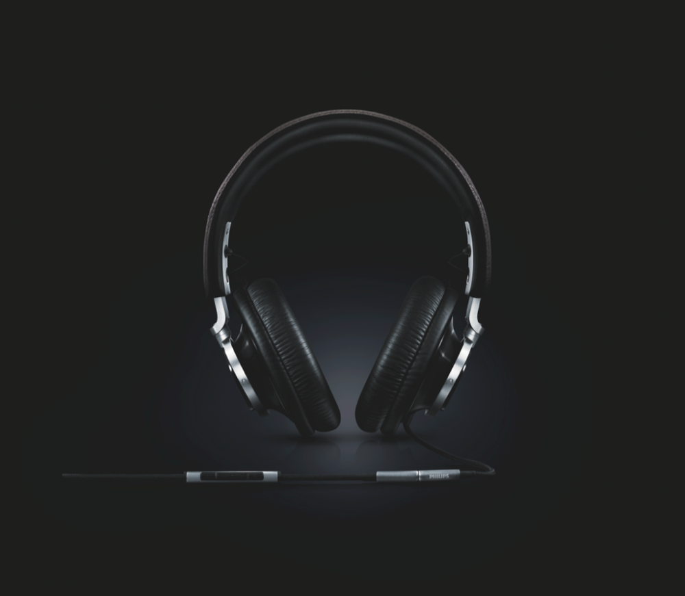 Professional studio shots of black wireless headphones rotating against dark background.