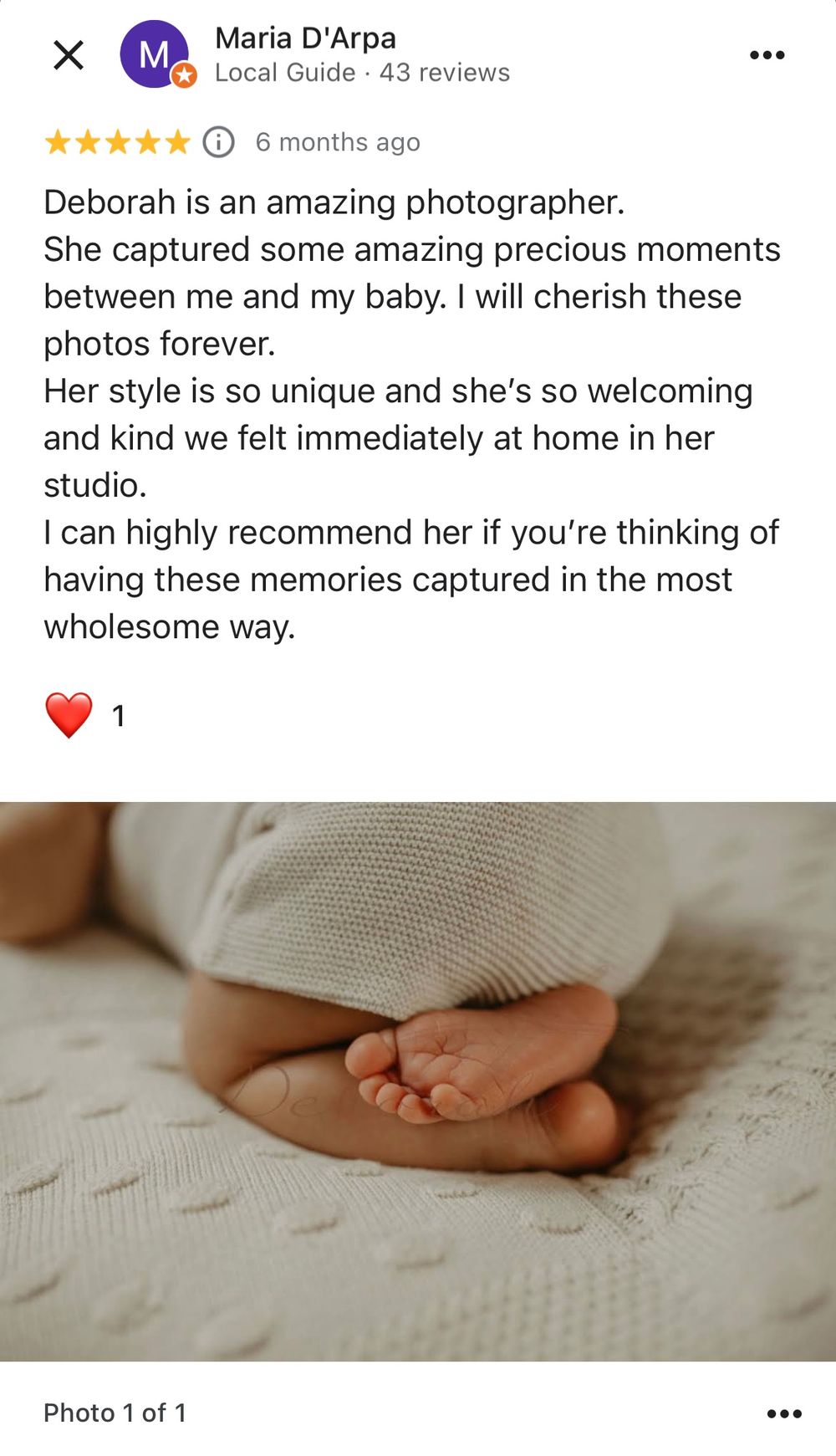 Close-up photo of tiny baby feet resting on textured white fabric in soft, natural lighting.