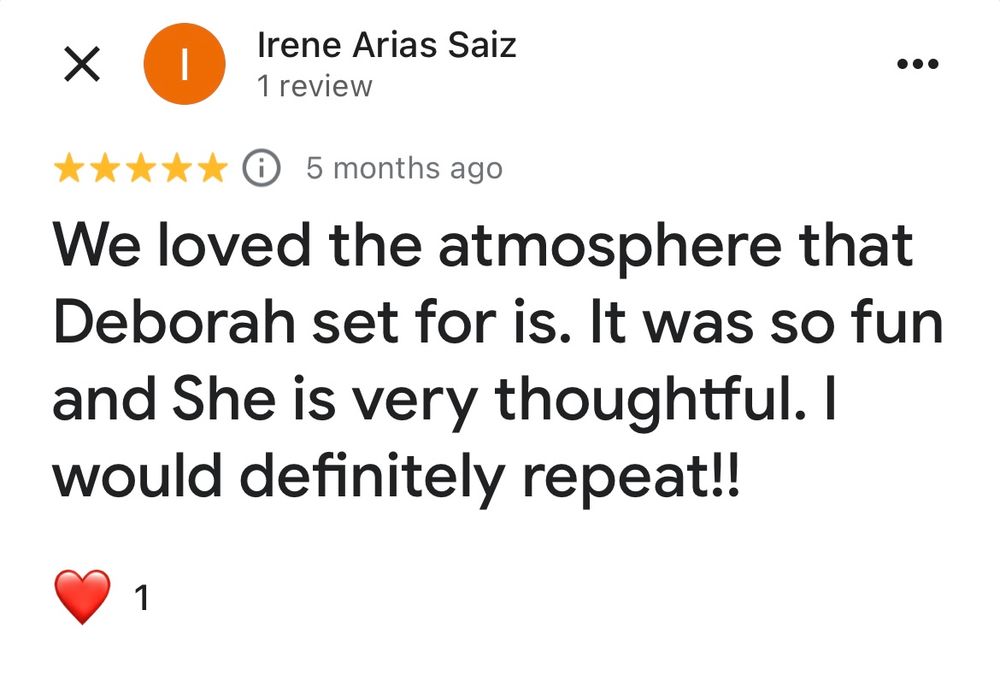 A five-star review comment showing positive feedback about a fun atmosphere with a red heart emoji reaction.