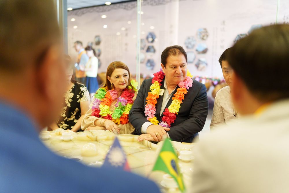 People seated around a table during a business meeting or workshop in an office environment.