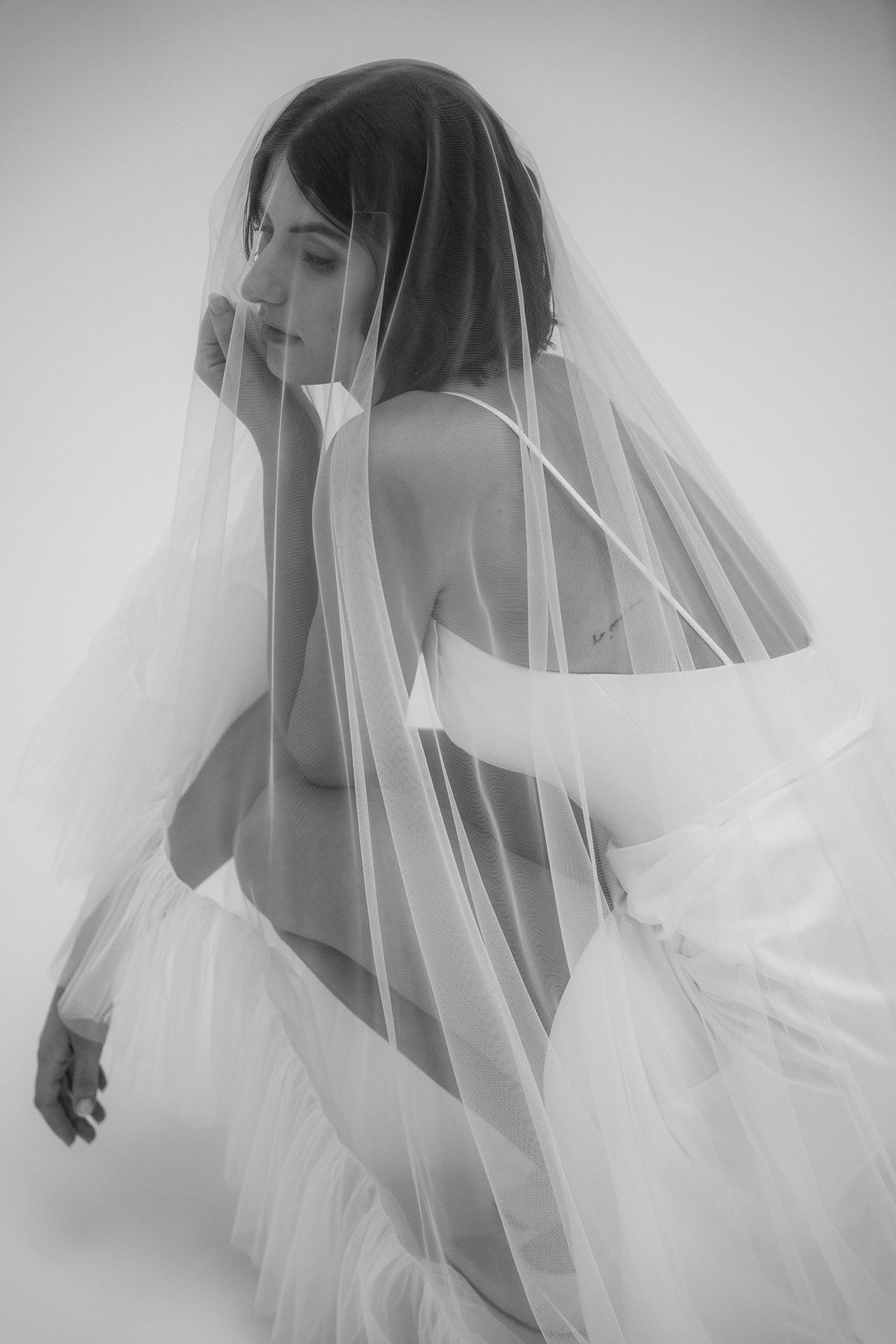 Ethereal series of shots showing movement under a flowing white veil.