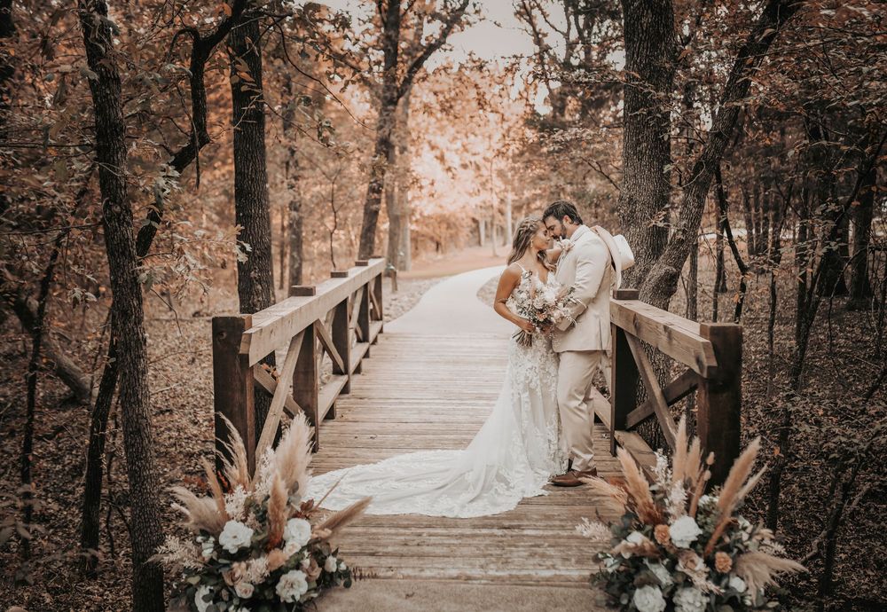 Romantic bride and groom portraits on the rustic wooden bridge at Whispering Oaks wedding venue