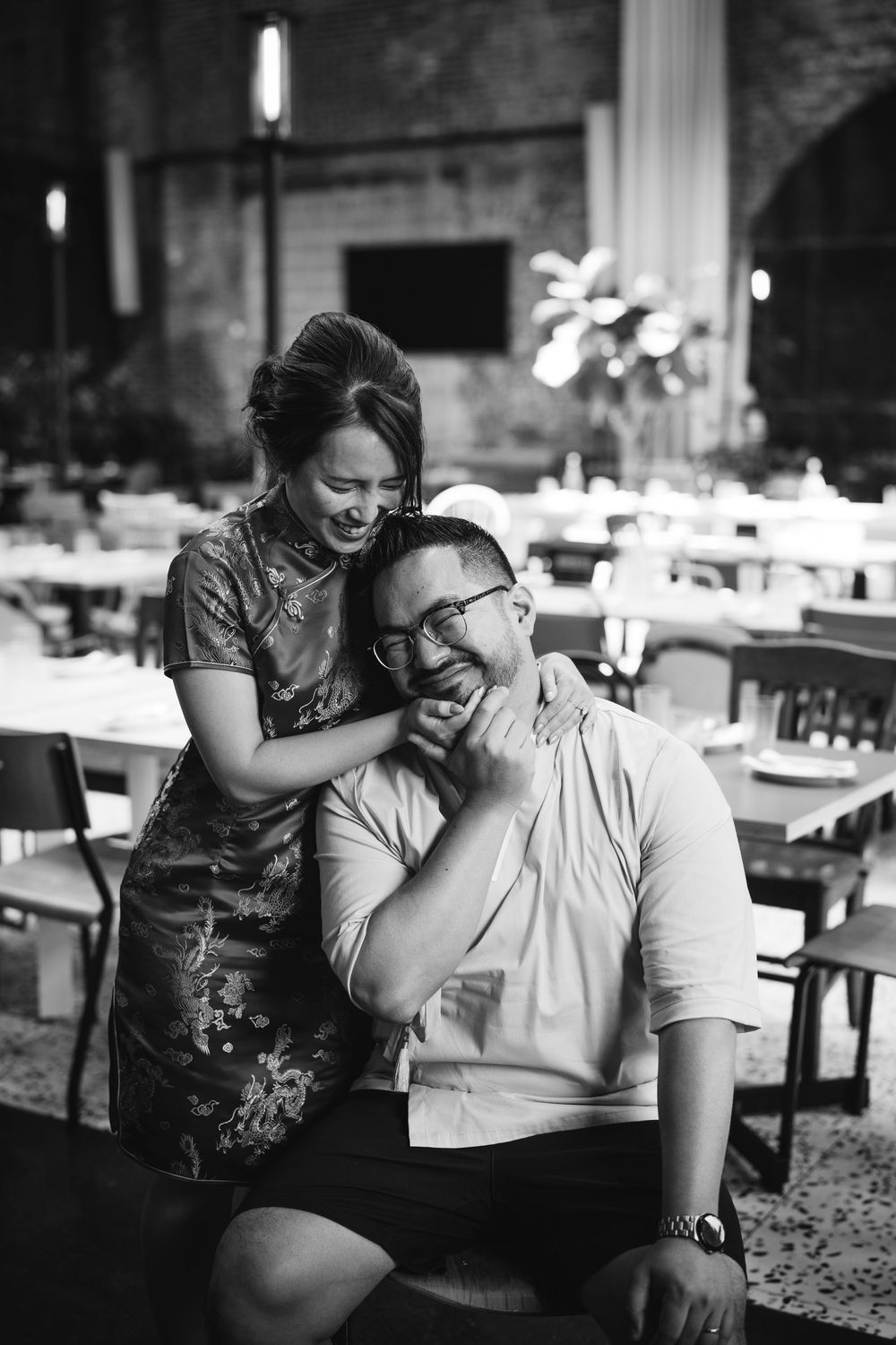 Four sequential black and white images show a romantic moment between a couple in a restaurant dining room. Picnic Fishtown