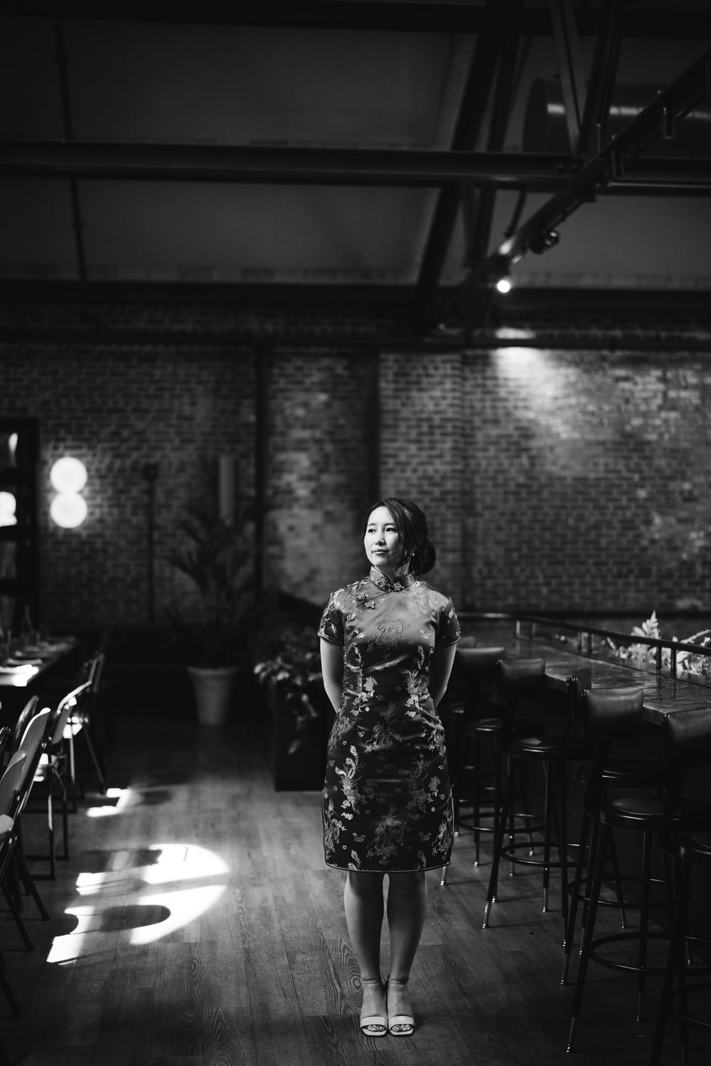 Artistic black and white composition of silhouetted figures in a dimly lit venue with dramatic lighting and smoke effects. Picnic Philly