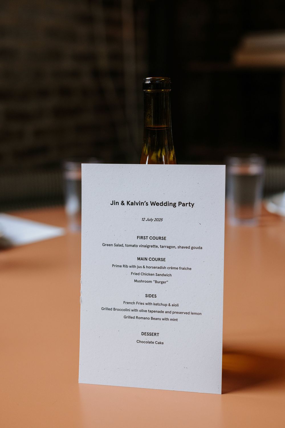 Wedding menu cards displayed on a wooden table showing 'Jim & Kaitlyn's Wedding Party' text. Picnic Philadelphia