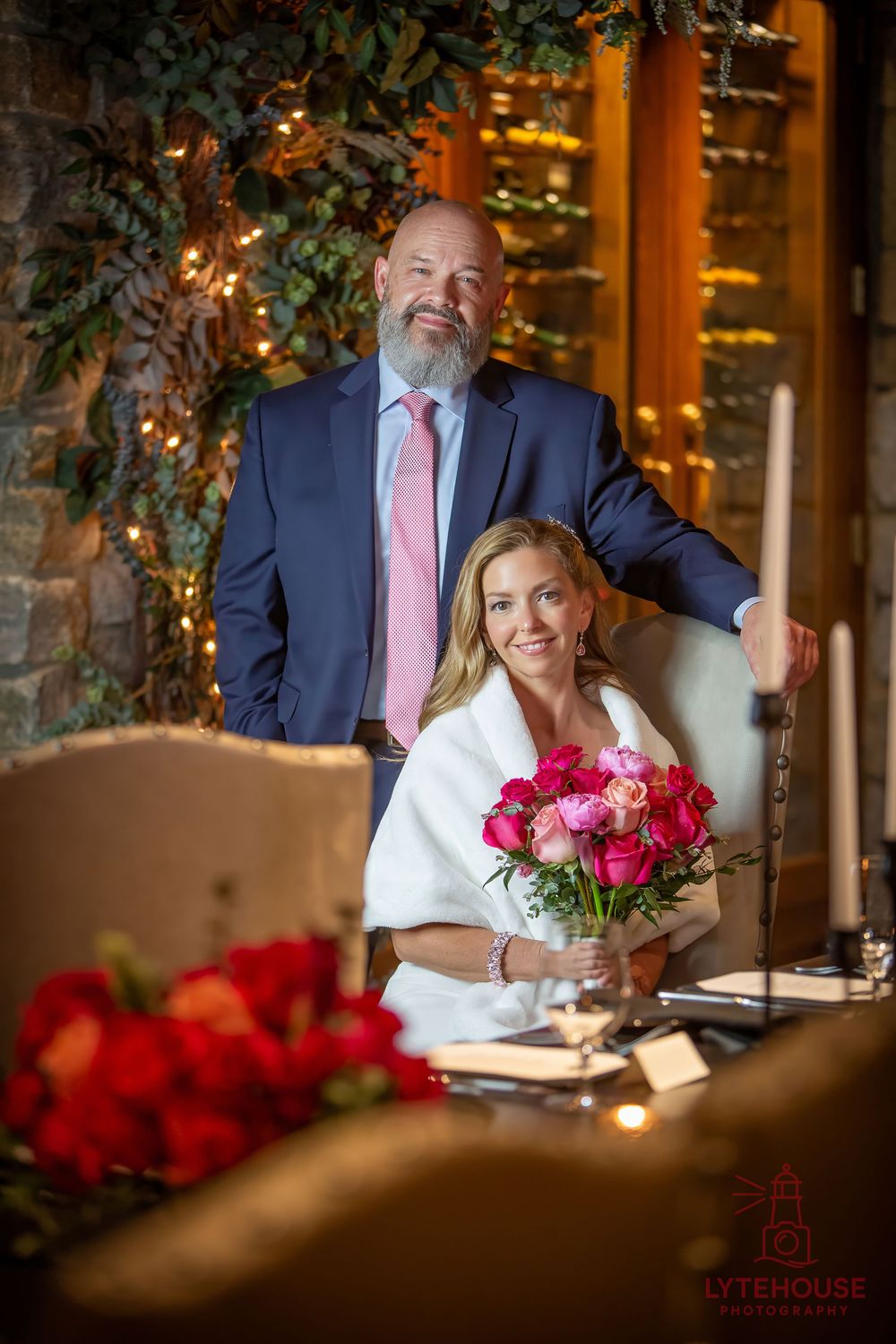 A romantic restaurant interior with flowers and decorative lighting captures a meaningful moment at an elegant table setting.