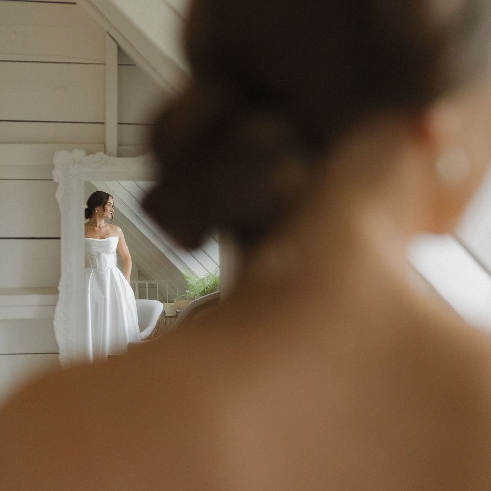 Soft focus artistic portrait in a bright white room with natural window light.