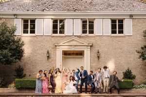 A collection of wedding party photos taken in front of a stone building with white trim and windows.