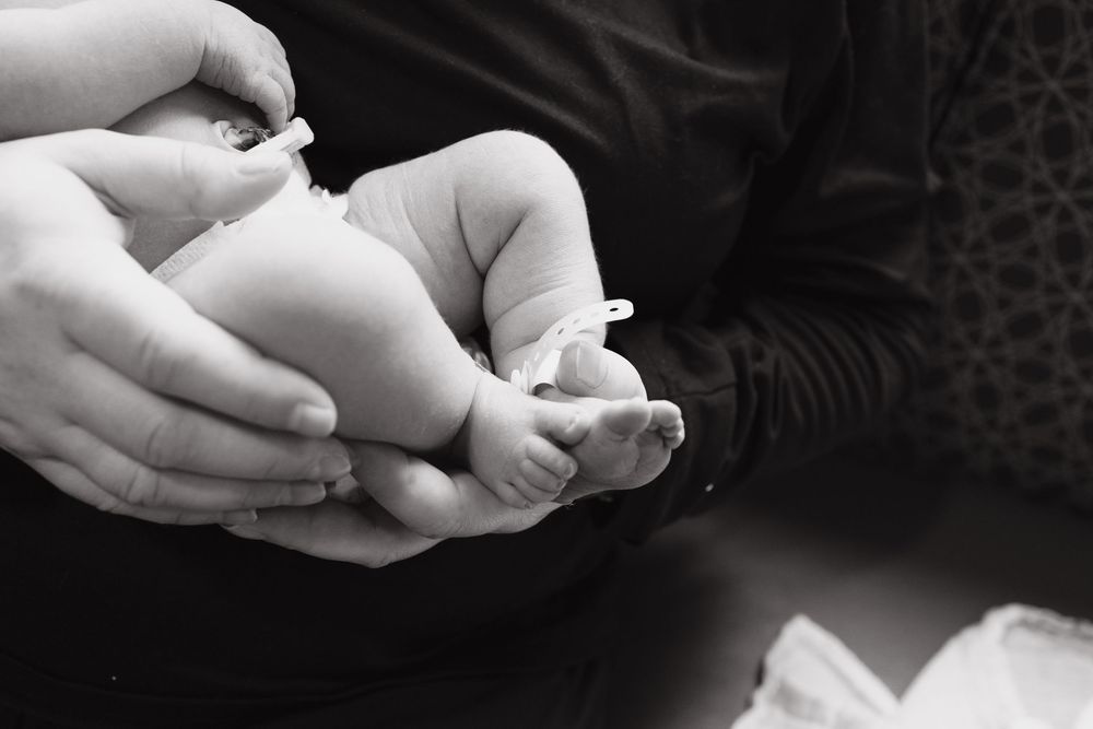 Series of black and white images showing a newborn baby peacefully sleeping.