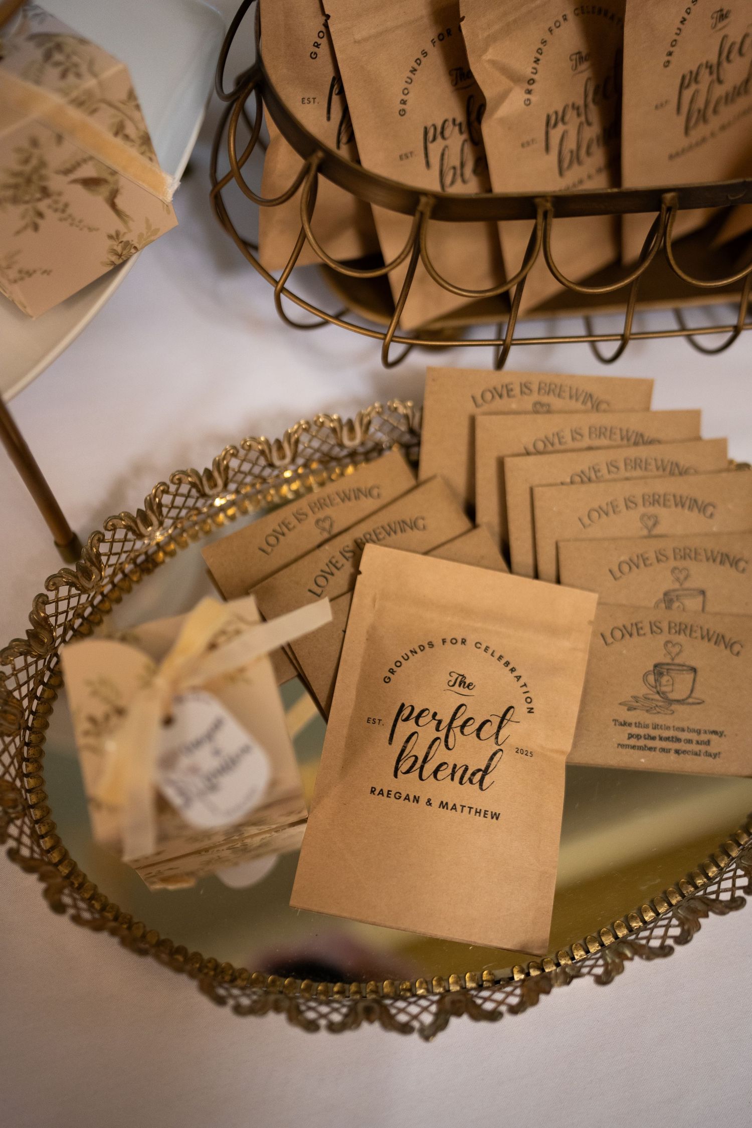 Wedding favor tags and place cards with ornate designs arranged on a doily-style decorative paper background.