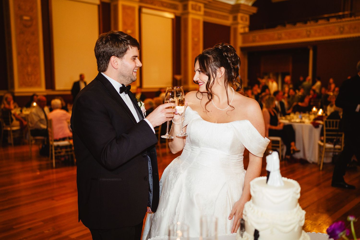 Wedding reception captures elegant moments on dance floor with formal attire and warm ambient lighting.