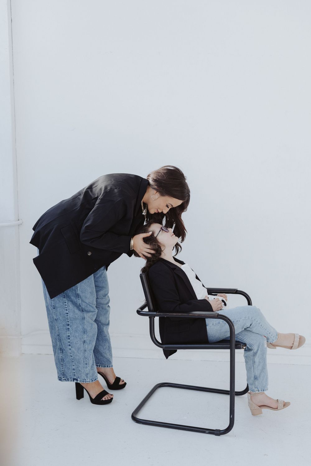 Creative poses with modern black chair showing different angles and perspectives.