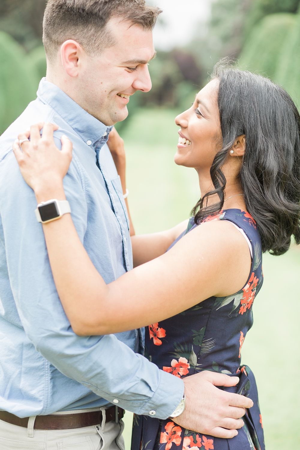 Joyful couple sharing a tender moment outdoors in natural lighting.