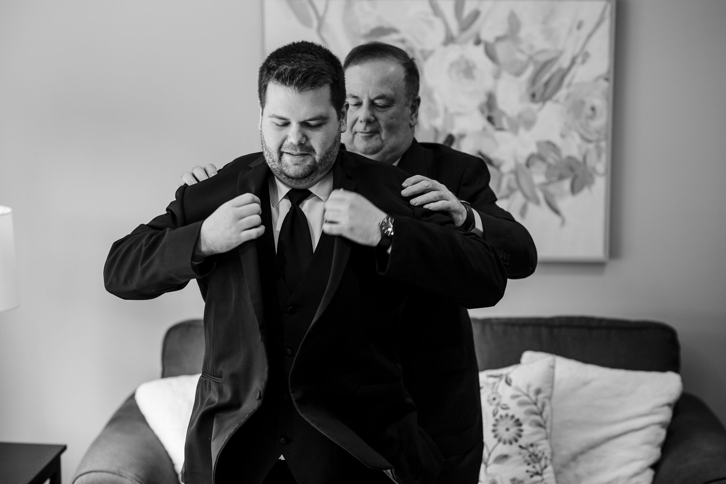 A series of black and white photos showing a couple embracing and sharing intimate moments during their wedding celebration.