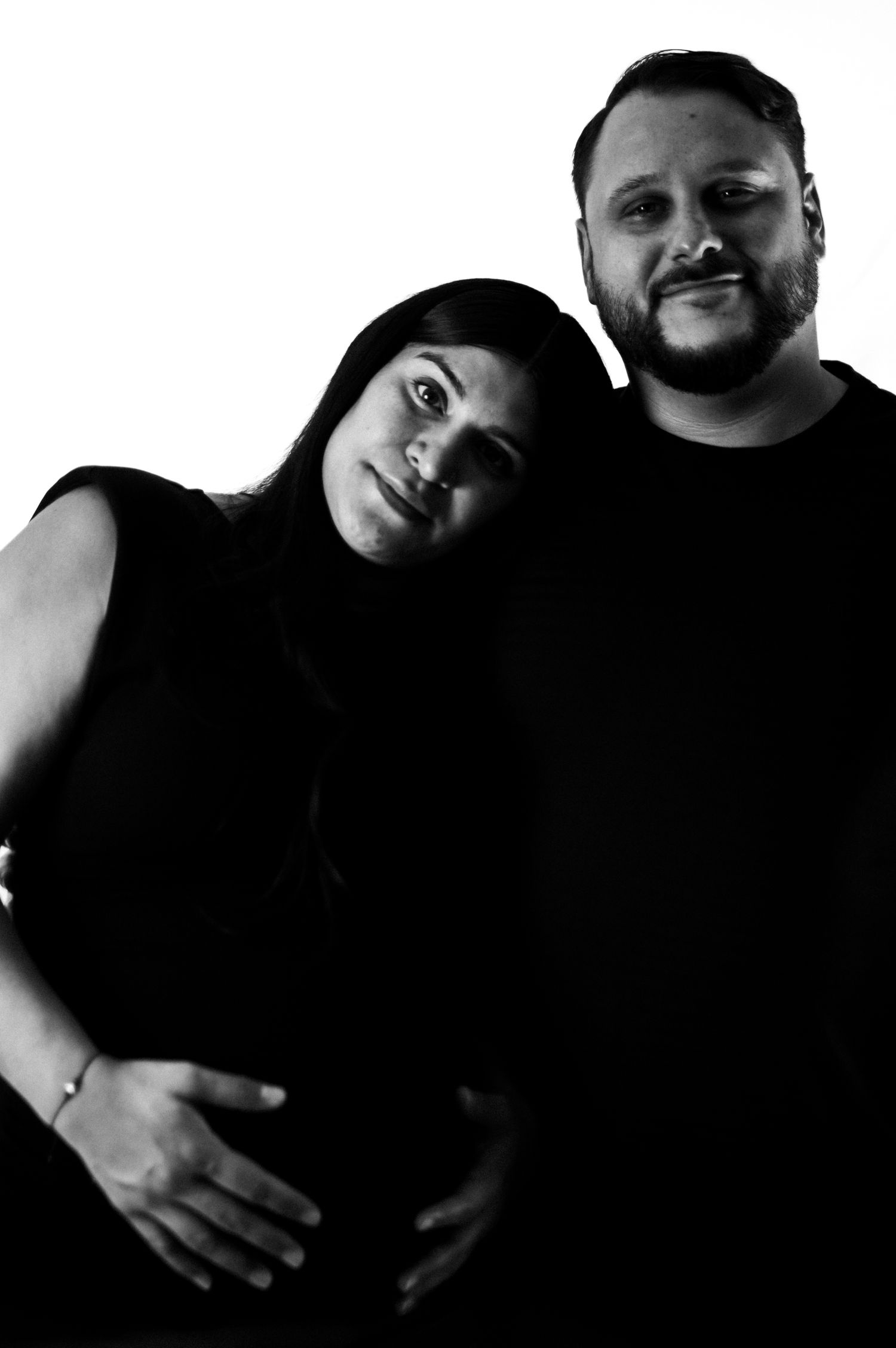 A series of four black and white photos showing people embracing in intimate poses.