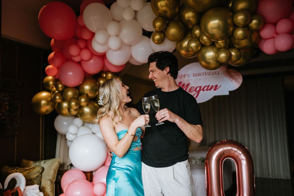 Elegant birthday celebration with metallic balloons and pink color scheme.