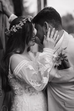 Black and white wedding portraits showing intimate moments between a couple with a delicate veil and floral details.