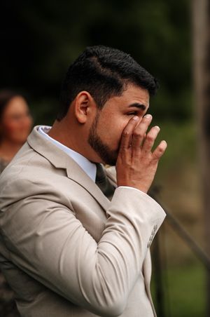 A series of emotional reactions showing someone in a light colored suit covering their face with their hand.
