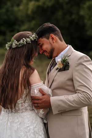 A tender sequence of wedding photos shows a romantic embrace between newlyweds in nature.