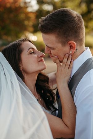 A romantic couple shares tender moments in a series of intimate outdoor portraits at sunset.
