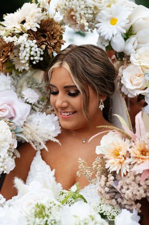 Delicate floral wedding arrangements featuring white daisies, roses and baby's breath create a soft, romantic atmosphere.