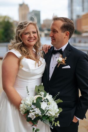 A newlywed couple shares intimate moments in a series of candid wedding photos with white floral bouquet.