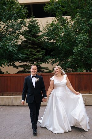 A sequence of candid wedding photos showing a couple walking together outdoors in formal attire.