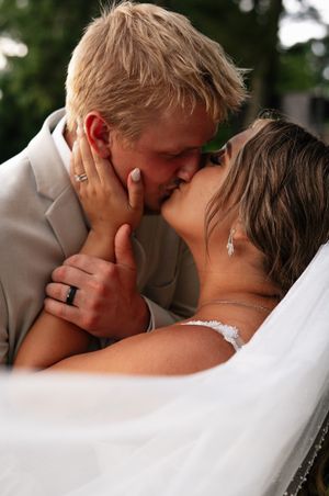 Wedding couple sharing a romantic close up kiss sequence in black and white photography style.
