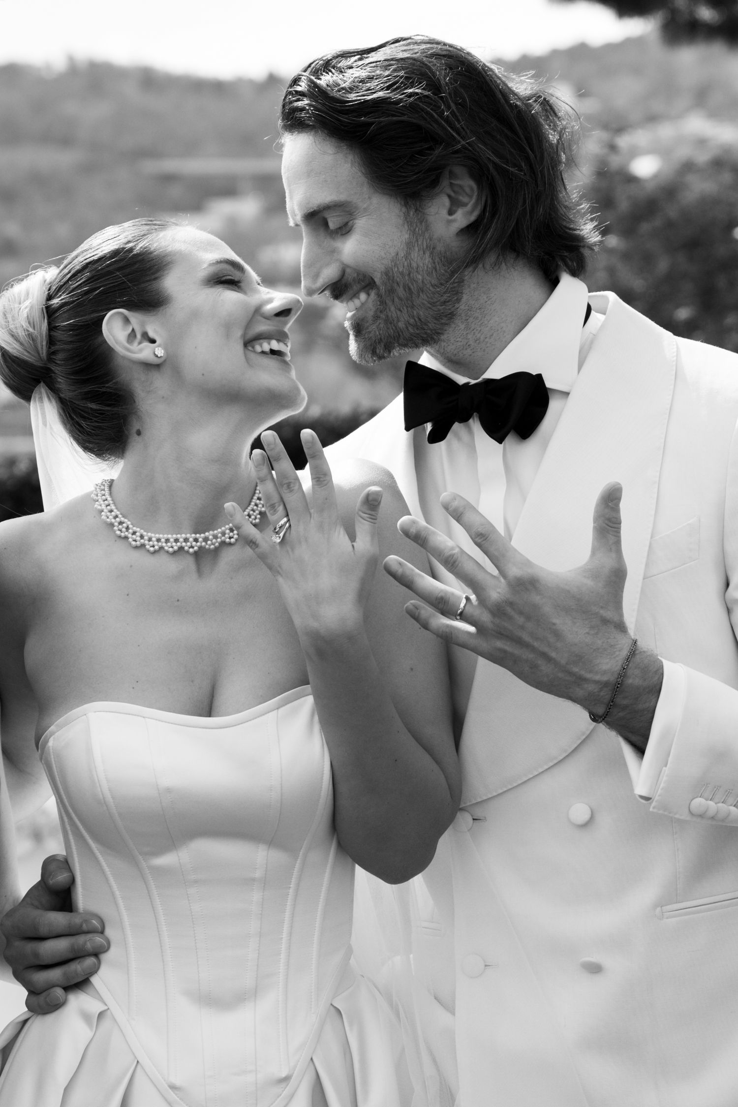 A romantic proposal moment overlooking a coastal mountain landscape with misty views of the Mediterranean Sea below.