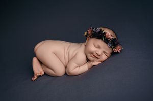 A series of newborn portraits showing peaceful sleeping poses against a dark background.
