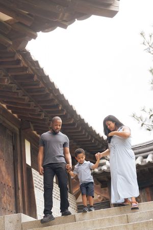 Stone steps and wooden beams line the exterior walkway of a traditional Korean building.