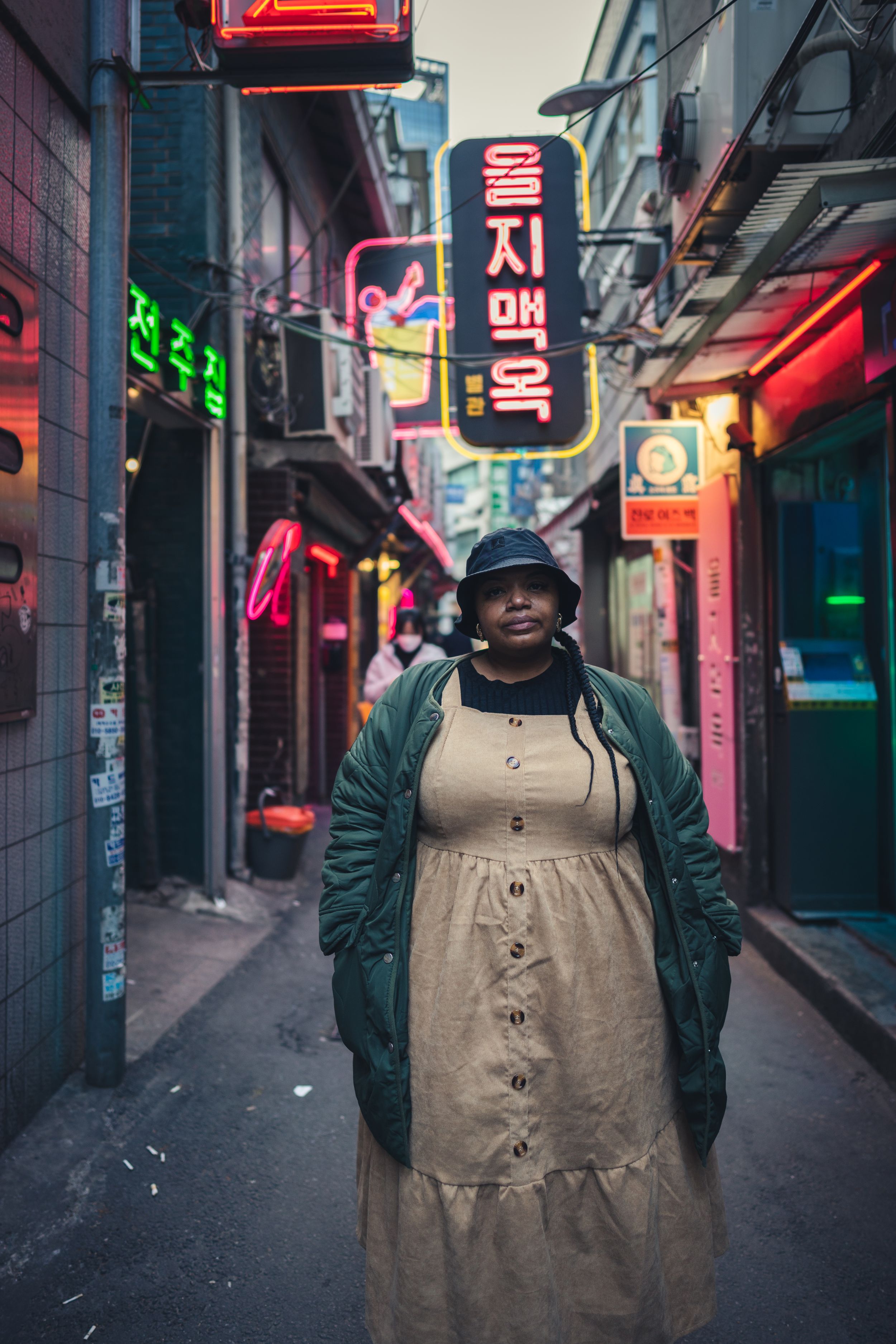 Neon signs illuminate a narrow alley in Korea's nightlife district.