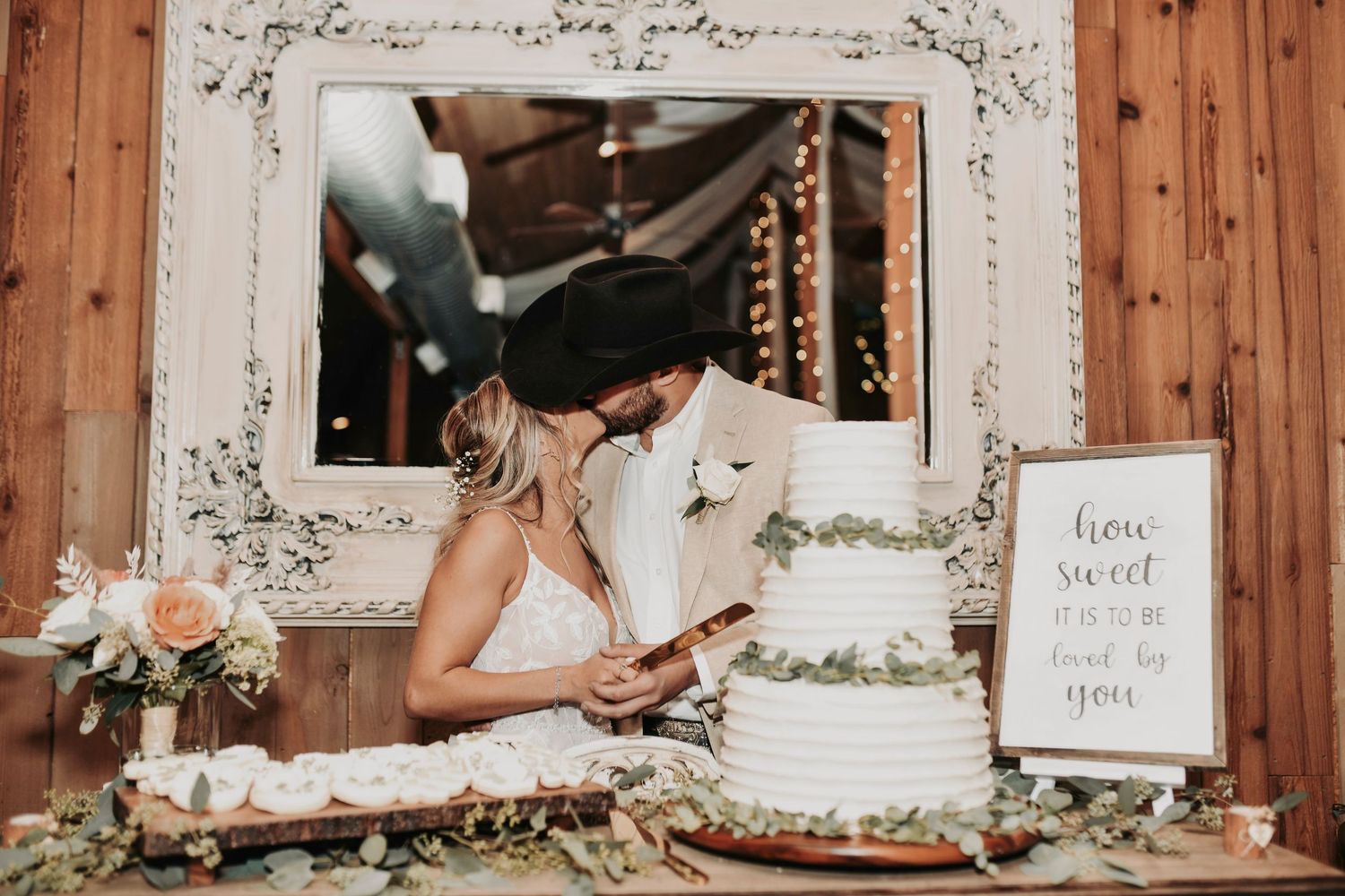 Bride and groom cutting rustic chic wedding cake at Whispering Oaks