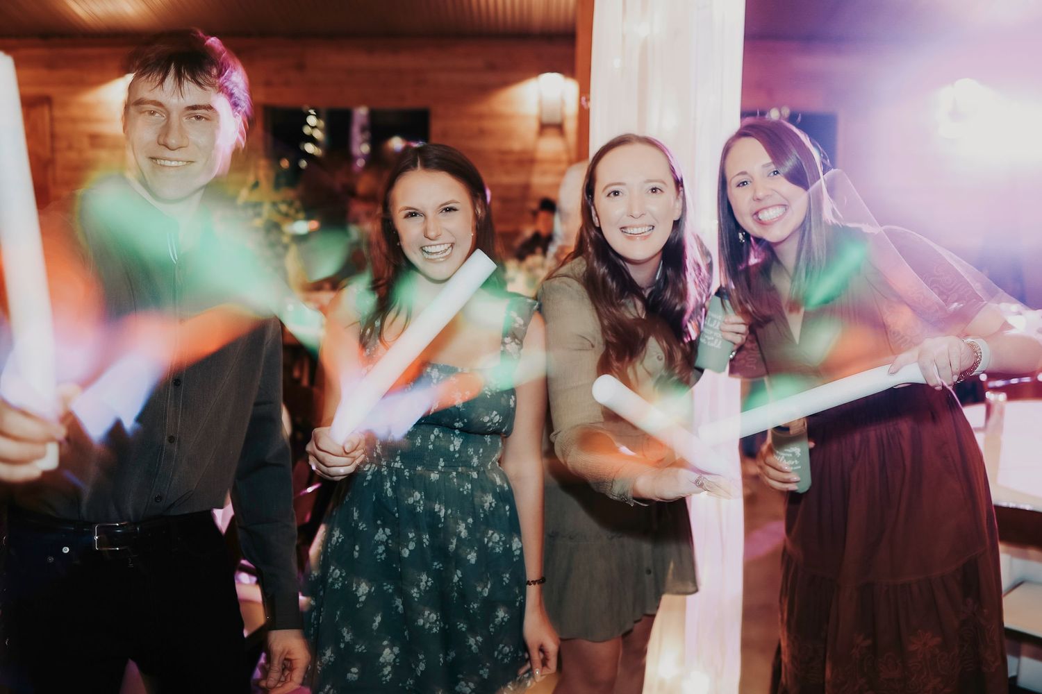 Wedding guests enjoying drinks, laughter, and music