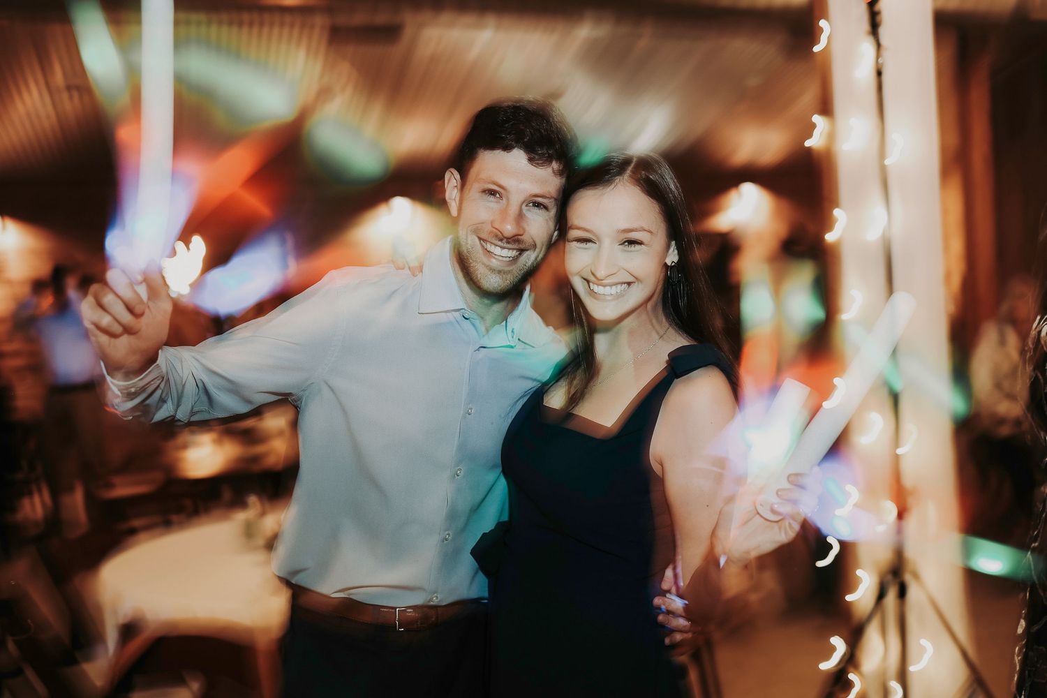Wedding guests enjoying drinks, laughter, and music