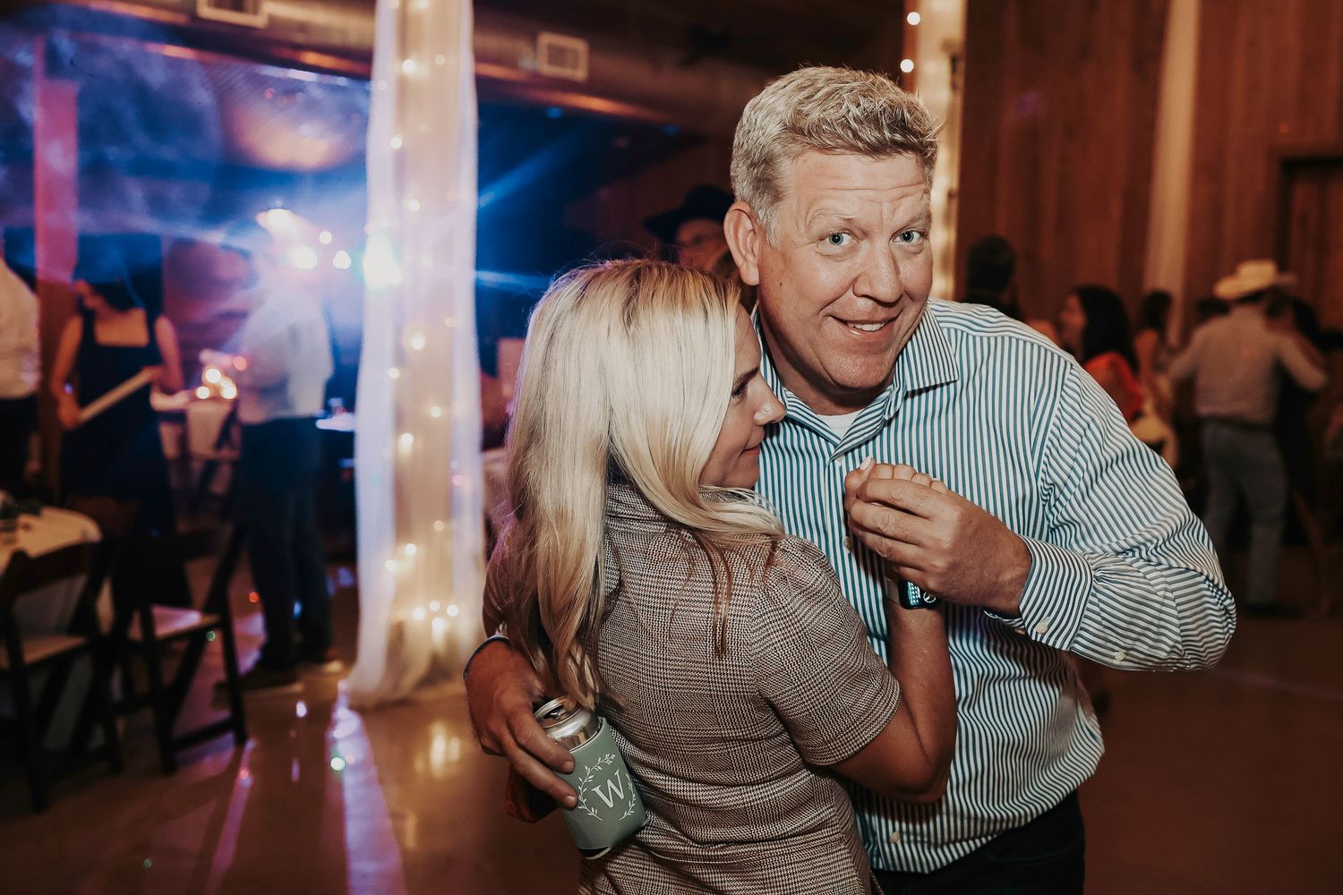 Wedding guests enjoying drinks, laughter, and music