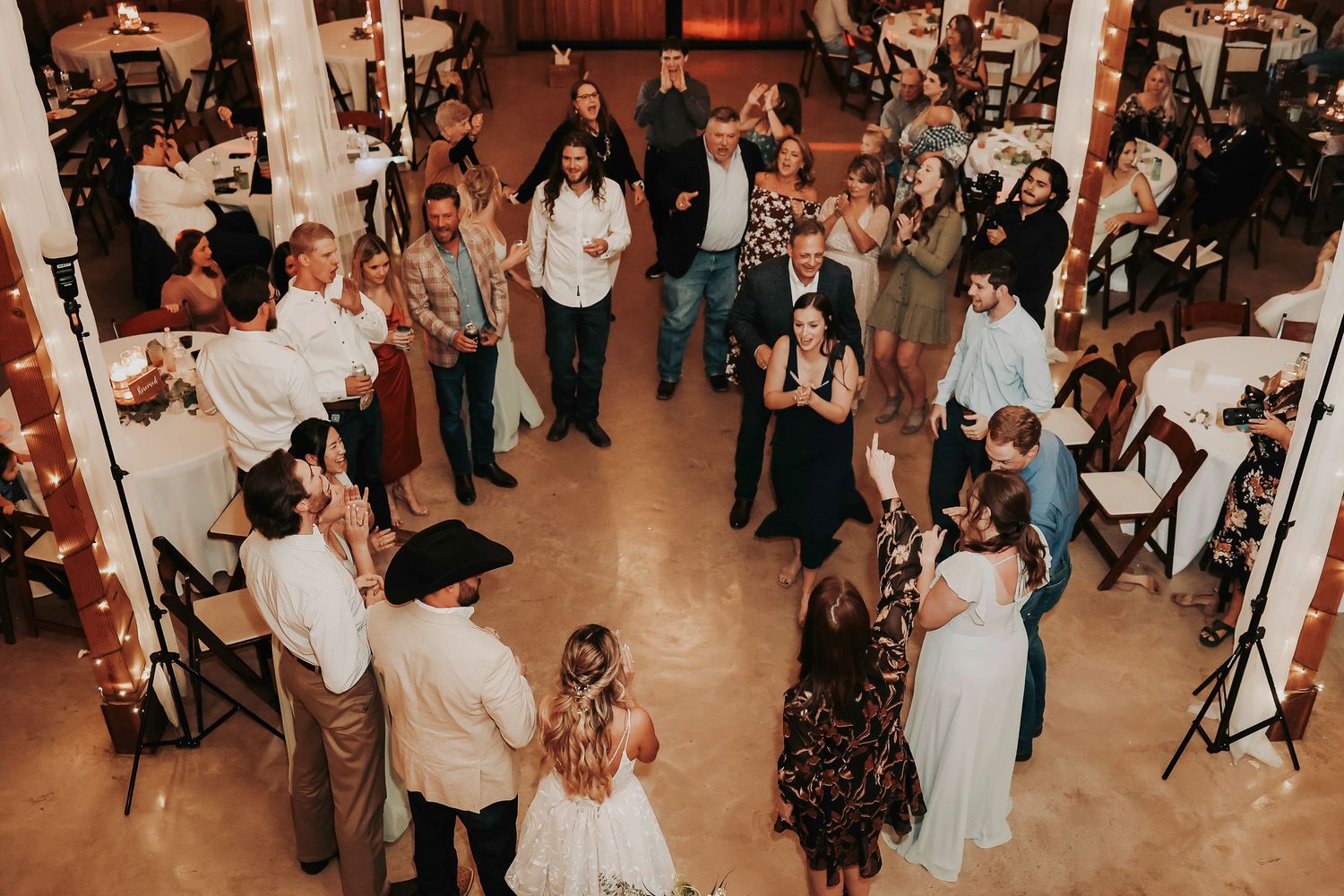 Guests dancing wildly at Whispering Oaks barn reception