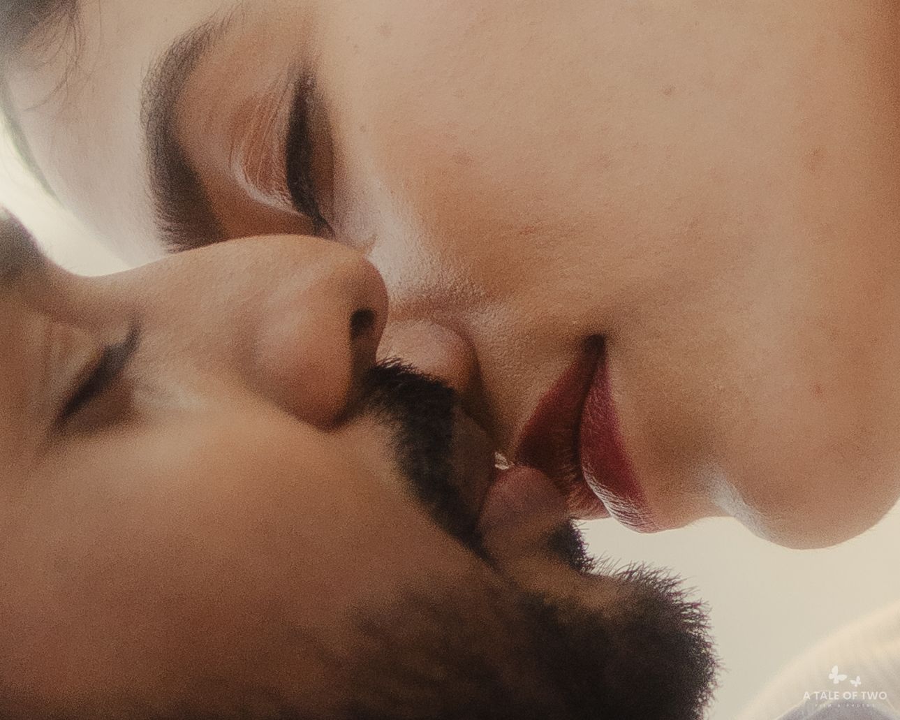 A tender intimate moment showing two people in a loving close embrace with soft lighting.