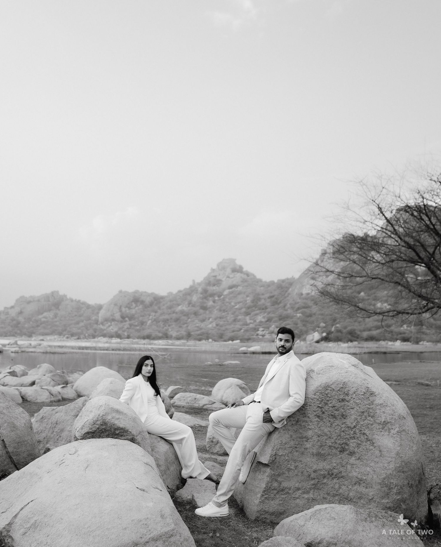 Four black and white photos show two people lounging on large rocks in an outdoor desert landscape setting.