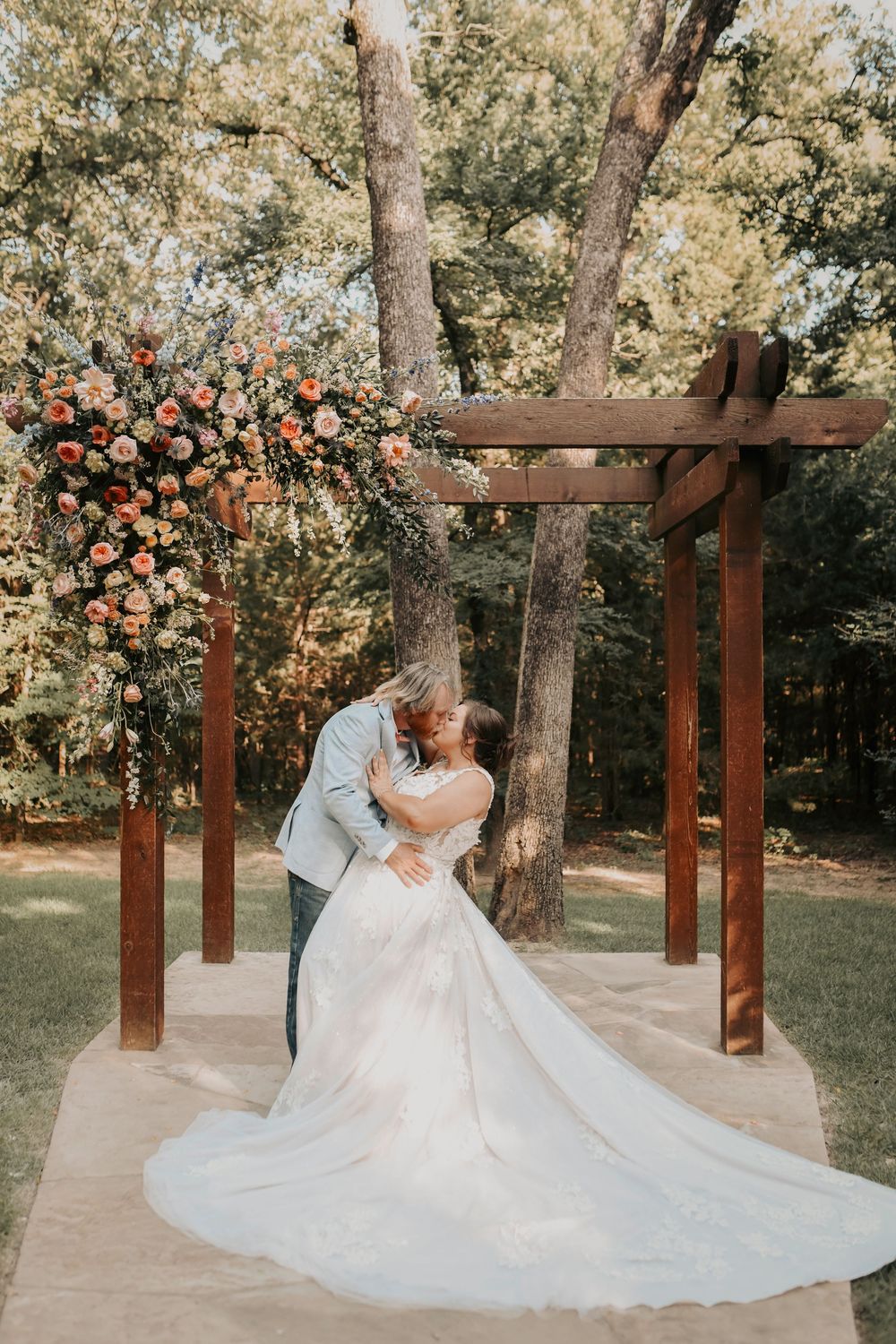 Close-up of bride and groom exchanging rings at Whispering Oaks