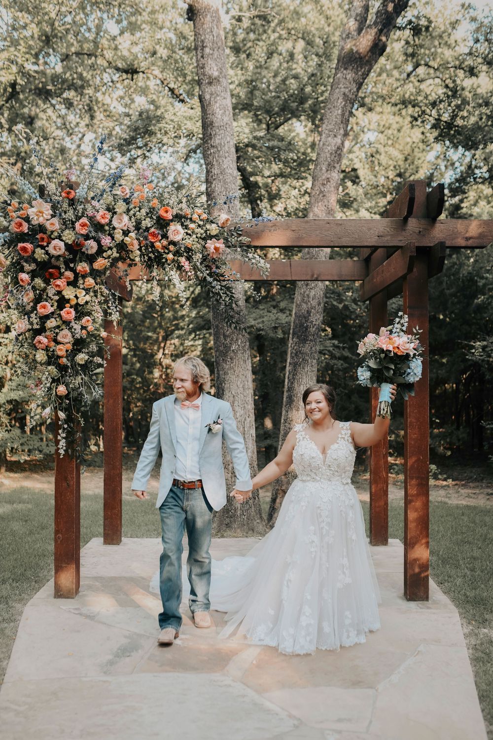 Bride and groom smiling during Whispering Oaks ceremony