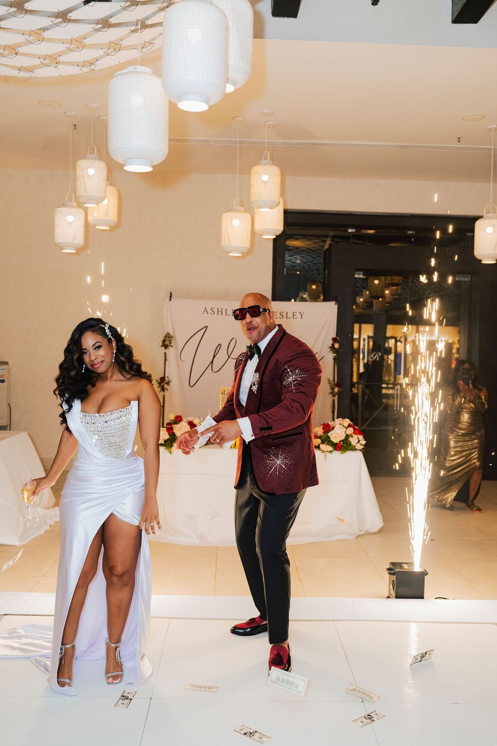 Dancers execute a dramatic move with pyrotechnic effects during a wedding reception.