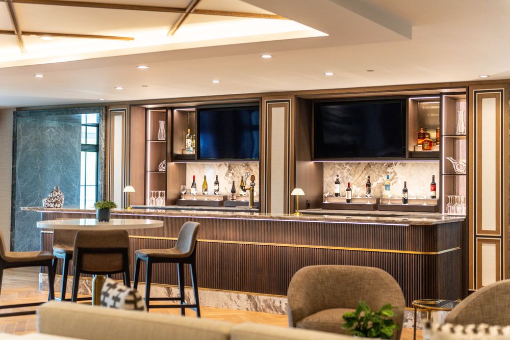 Whistlebear Golf Club - Modern luxury retail jewelry display cases with warm lighting and blue accent wall.