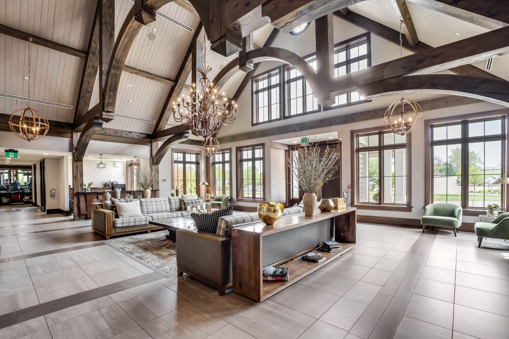 Contemporary venue with cathedral ceiling, exposed beams, and large windows providing natural light.
