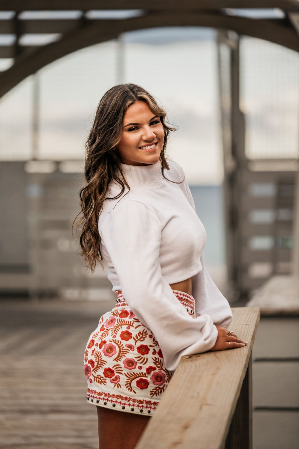 Creative senior portraits near Miramar Beach, FL, with coastal charm. Creative posing ideas for senior portraits.