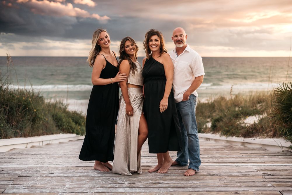 Stunning Family Portrait on the steps of Seaside Shops leading out to a dramatic sky during sunset golden hour with MJphotograph