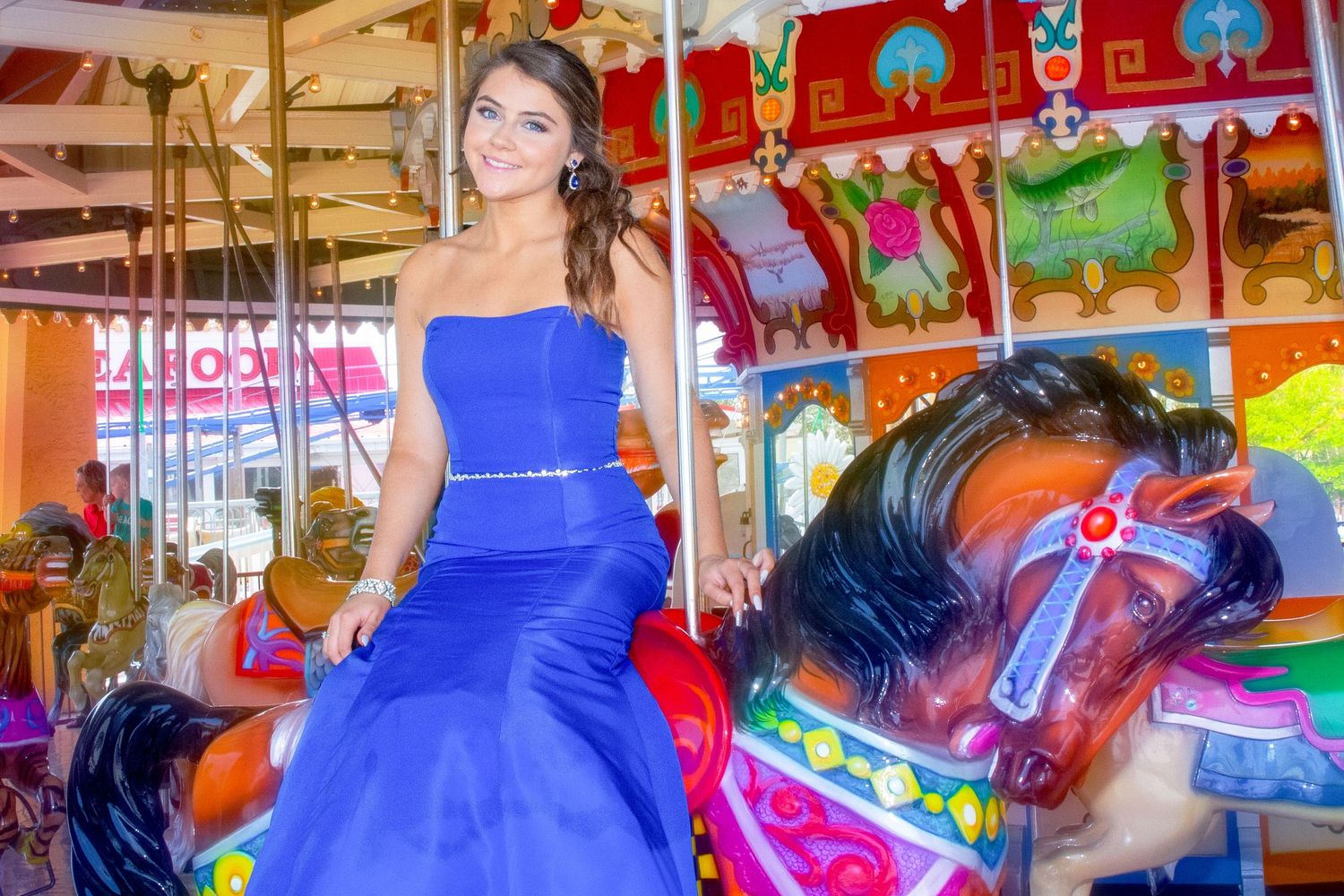 Graduation portrait with proud smile and carnival  in the background, Essex-County.