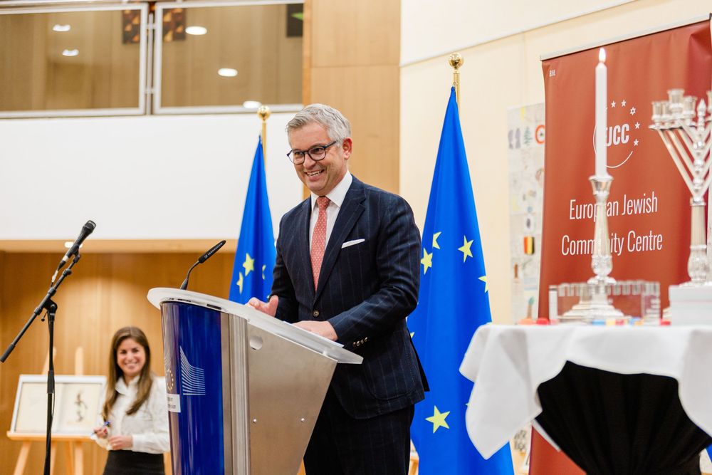 Corporate event photographer in Europe highlighting executive exchange during business summit.