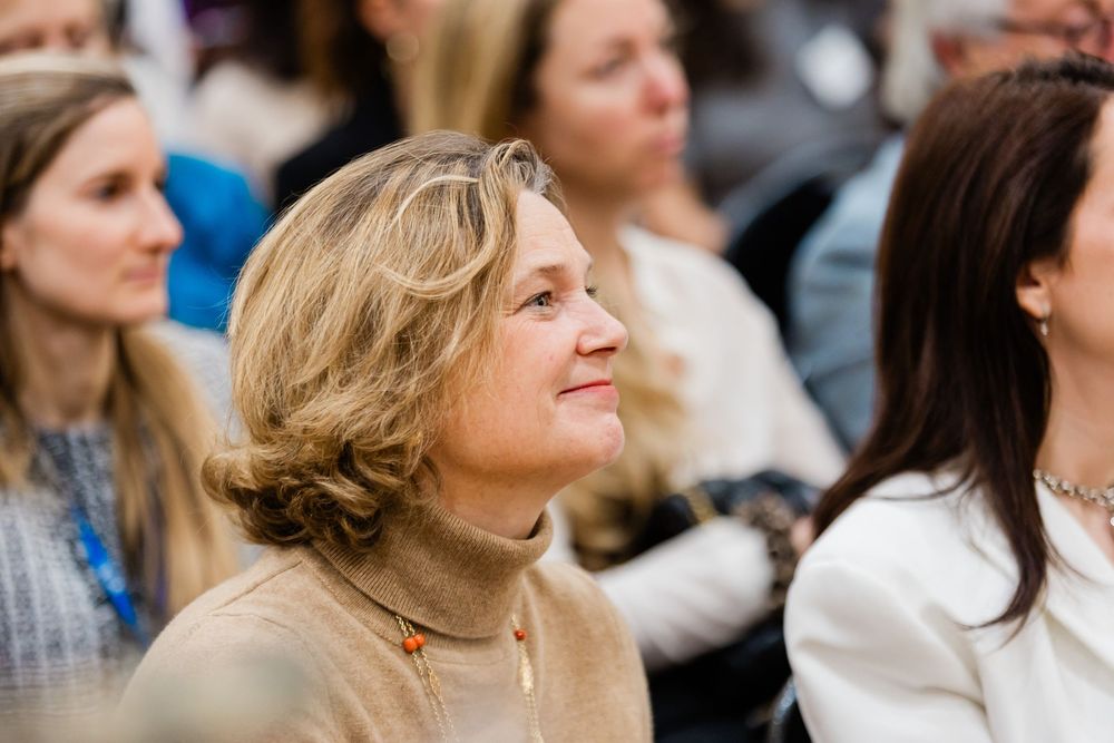 Corporate event photographer in Europe highlighting executive exchange during business summit.