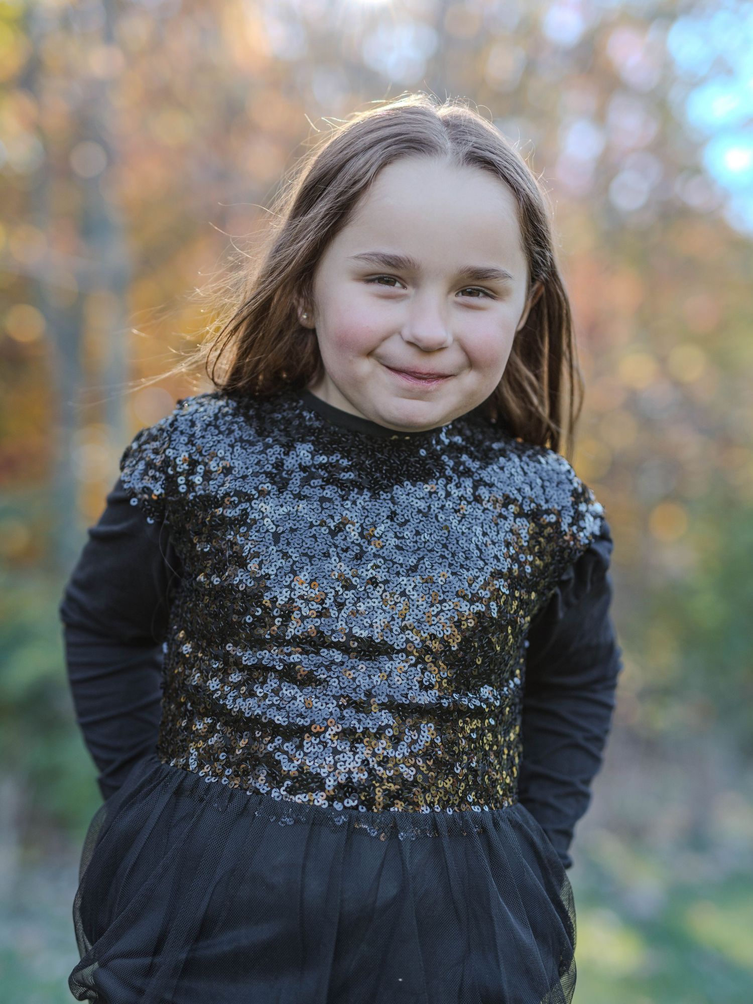 Child in black outfit with autumn colors in Windsor Ontario, Tasha Cannaday Photography